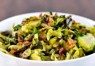 Brussels sprouts with bacon and pomegranate seeds on a plate